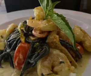 Sauteed shrimp over pasta